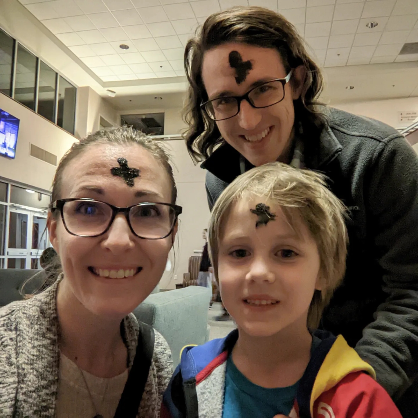 family with ash crosses on foreheads